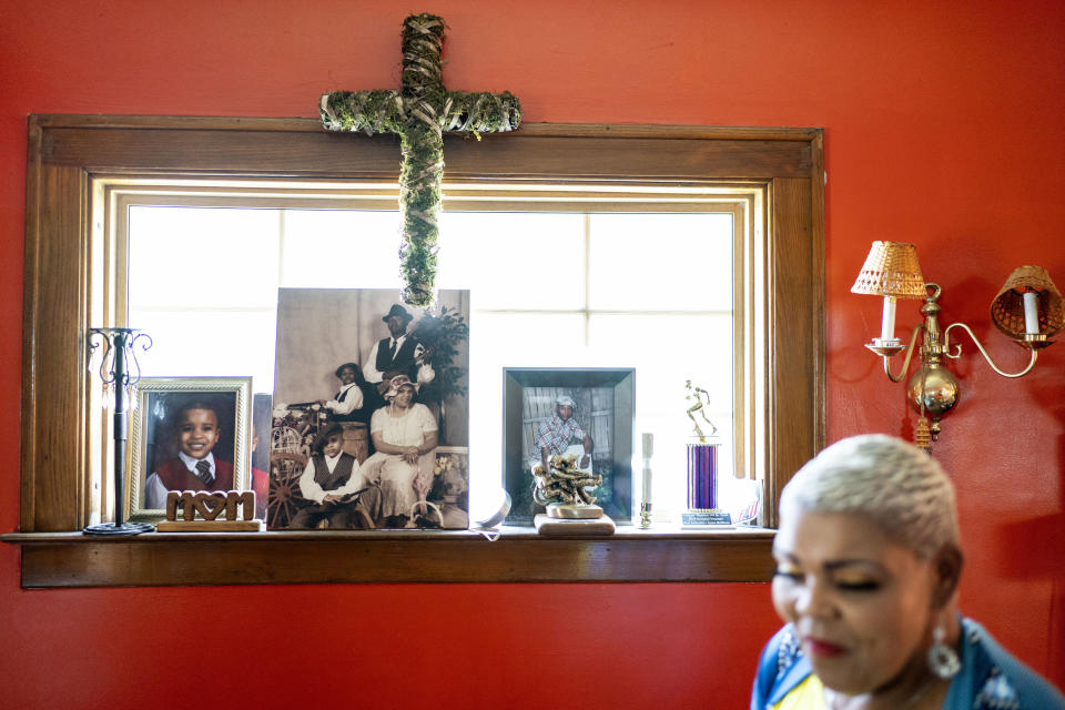 Family photos including a picture of her son, Jaylan, center photo rear, decorate a window in Marsha McWilson's home, Sunday, Aug. 20, 2023, in Niagara Falls, N.Y. "This is not the answer!" Jaylan's mother screamed during a sidewalk vigil for her son, shot dead at 24 as he arrived home one evening in late January, within sight of Trinity Baptist Church. "God gave me a miracle son! And now he's gone in the blink of an eye!" (AP Photo/David Goldman)