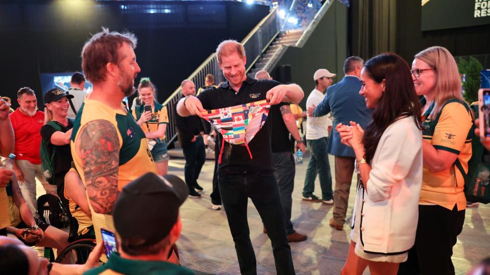 <p> While attending the Invictus Games in Dusseldorf in 2023, Meghan Markle was caught with an expression that many spouses might relate to - one which suggests "no, these aren't coming home with us." </p> <p> The funny photo of Meghan, trying her best to not show too much in her face, has her eyeing a pair of snazzy Speedos presented to Prince Harry by delegates of the Games. </p>