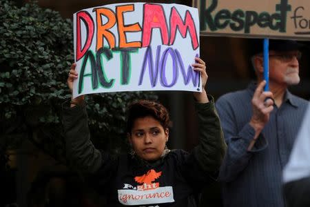 A women demanding action by the federal government on the Deferred Action for Childhood Arrivals (DACA) protests with a small group in downtown San Diego, California, U.S., December 4, 2017. REUTERS/Mike Blake/Files