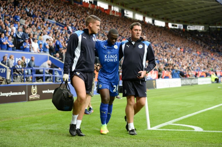 Leicester City's midfielder Nampalys Mendy (C) limps around the pitch after getting injured and being substituted on August 20, 2016