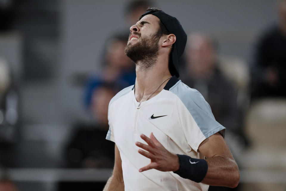 Russia's Karen Khachanov reacts after missing a shot against Spain's Carlos Alcaraz during their fourth round match at the French Open tennis tournament in Roland Garros stadium in Paris, France, Sunday, May 29, 2022. (AP Photo/Thibault Camus)
