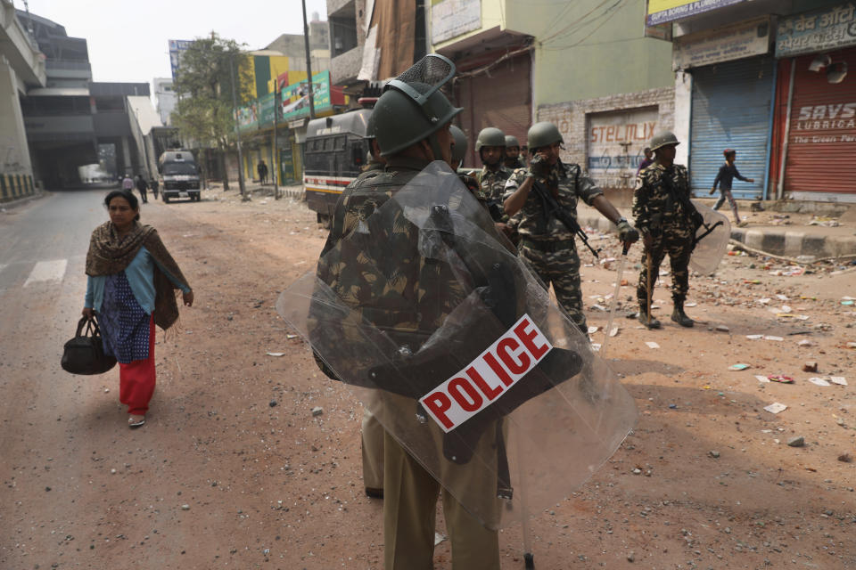 Indian paramilitary soldiers stand guard after Tuesday's violence in New Delhi, India, Wednesday, Feb. 26, 2020. At least 20 people were killed in three days of clashes in New Delhi, with the death toll expected to rise as hospitals were overflowed with dozens of injured people, authorities said Wednesday. The clashes between Hindu mobs and Muslims protesting a contentious new citizenship law that fast-tracks naturalization for foreign-born religious minorities of all major faiths in South Asia except Islam escalated Tuesday. (AP Photo/Manish Swarup)