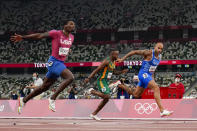 Lamont Jacobs, right, of Italy, wins the men's the 100-meter final at the 2020 Summer Olympics, Sunday, Aug. 1, 2021, in Tokyo. (AP Photo/David J. Phillip)