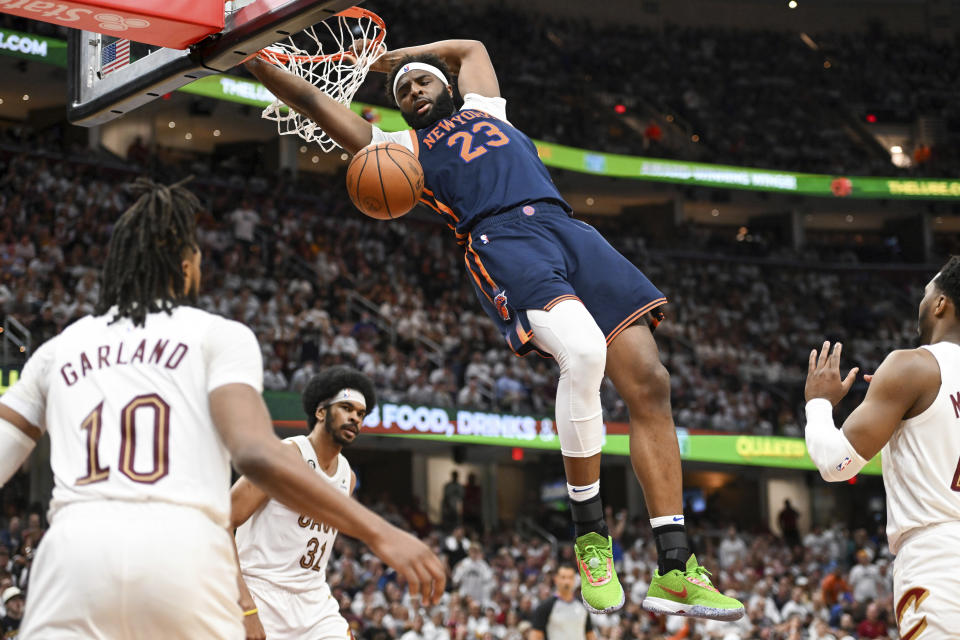 New York Knicks' Mitchell Robinson (23) dunks against the Cleveland Cavaliers during the second half of Game 1 in a first-round NBA basketball playoffs series Saturday, April 15, 2023, in Cleveland. (AP Photo/Nick Cammett)