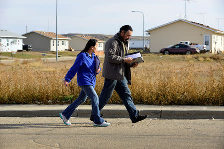 Michelle Chasing Hawk and Ira Hanson canvass voters in Porcupine, North Dakota ahead of the 2018 mid-term elections on the Standing Rock Reservation, U.S. October 26, 2018. REUTERS/Dan Koeck
