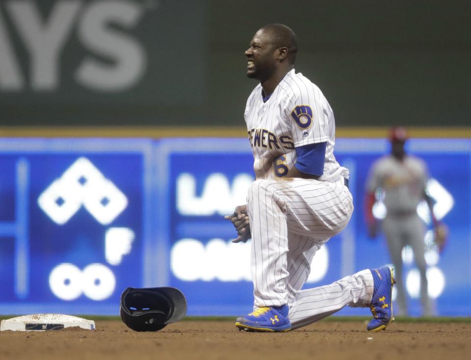 Milwaukee Brewers' Lorenzo Cain holds his hand after being caught stealing second during the fifth inning of a baseball game against the St. Louis Cardinals Friday, March 29, 2019, in Milwaukee. (AP Photo/Morry Gash)