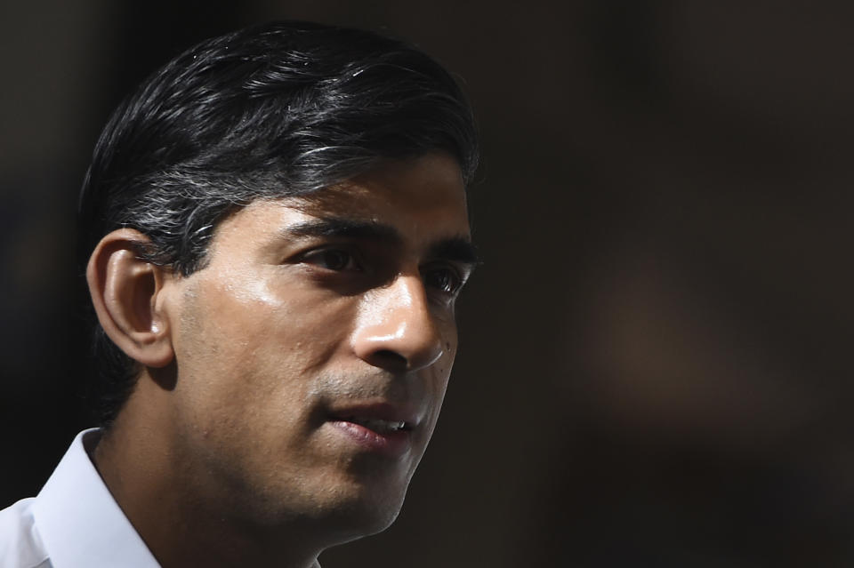 Britain's Chancellor of the Exchequer Rishi Sunak, left, during a visit to Peak Scientific, a Scottish manufacturer of gas generators for analytical laboratories, in Glasgow, Scotland, Friday Aug. 7, 2020. (Andy Buchanan/PA via AP)