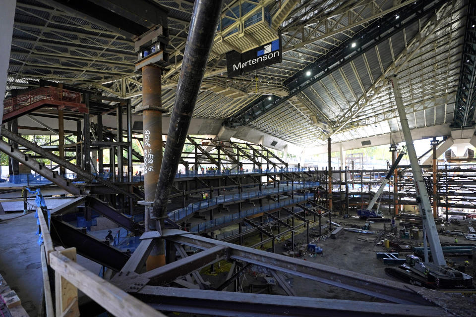 The historic roof of the former KeyArena and a tiered seating area are shown Tuesday, Sept. 1, 2020, as work continues on the Climate Pledge Arena in Seattle, the home of the Seattle Kraken NHL hockey team. Sometime in the late summer or early fall of 2021, the Kraken will open the new facility -- at a cost that will likely total $1 billion by the time it's done -- and become the NHL's 32nd franchise. (AP Photo/Ted S. Warren)