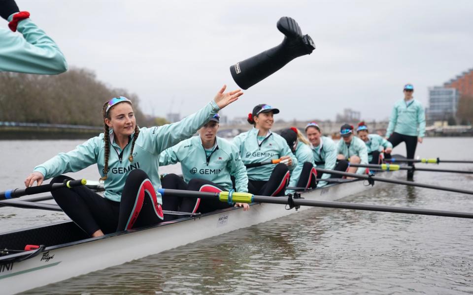 Cambridge's Caoimhe Dempsey removes her wellies before the start of the women's race - PA