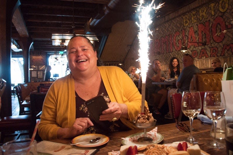 We'll tell food stories worth celebrating at our next Storytellers Project event. (This is me at one of my happy places: a table with friends, foods and sparkle.)