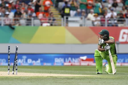 Pakistan's Sarfraz Ahmed looks at his shattered stumps after being run out during their Cricket World Cup match against South Africa in Auckland, March 7, 2015. REUTERS/Nigel Marple