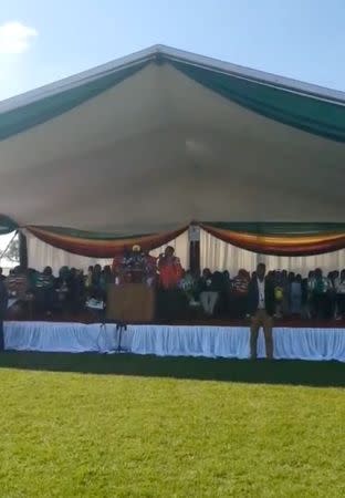 Zimbabwe President Emmerson Mnangagwa addresses the crowd at a political rally, earlier in the day before an explosion rocked the stadium, in Bulawayo, Zimbabwe June 23, 2018 in this still image taken from a video obtained from social media. TIRIMUSANGO WENJE/via REUTERS