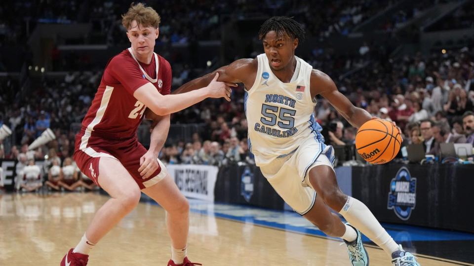 March 28, 2024;  Los Angeles, CA, USA;  North Carolina Tar Heels forward Harrison Ingram (55) controls the ball against Alabama Crimson Tide forward Sam Walters (24) in the second half in the West Regional semifinals of the 2024 NCAA Tournament at Crypto.com Arena. 
