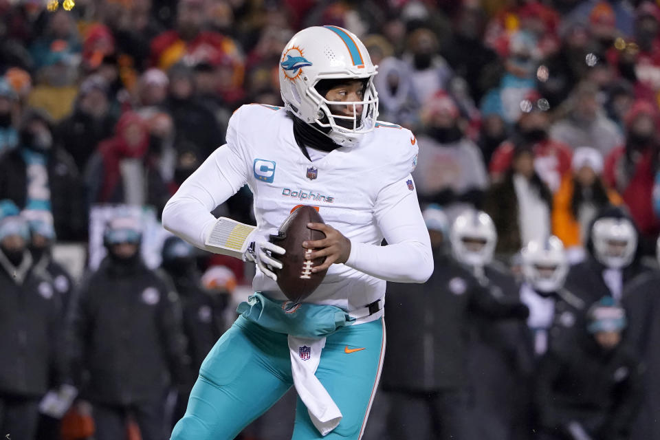 Miami Dolphins quarterback Tua Tagovailoa rolls out to pass against the Kansas City Chiefs during the first half of an NFL wild-card playoff football game Saturday, Jan. 13, 2024, in Kansas City, Mo. (AP Photo/Ed Zurga)