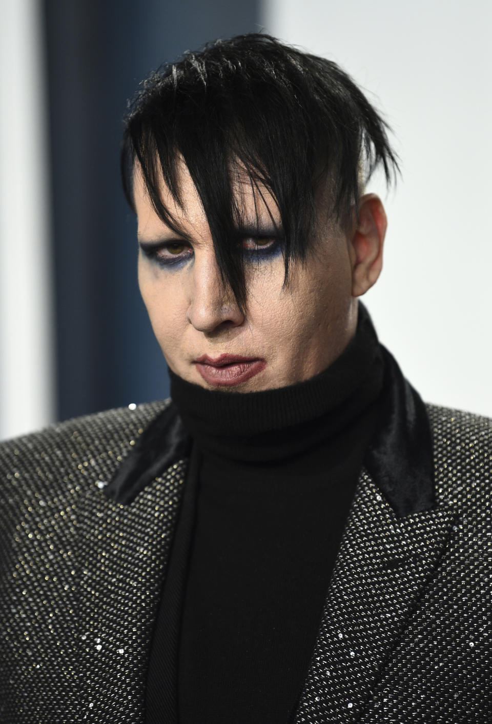 FILE - Marilyn Manson arrives at the Vanity Fair Oscar Party on Feb. 9, 2020, in Beverly Hills, Calif. Manson was dropped by his record label Monday after his ex-fiancé, the actor Evan Rachel Wood, accused him of sexual and other physical abuse. (Photo by Evan Agostini/Invision/AP, File)