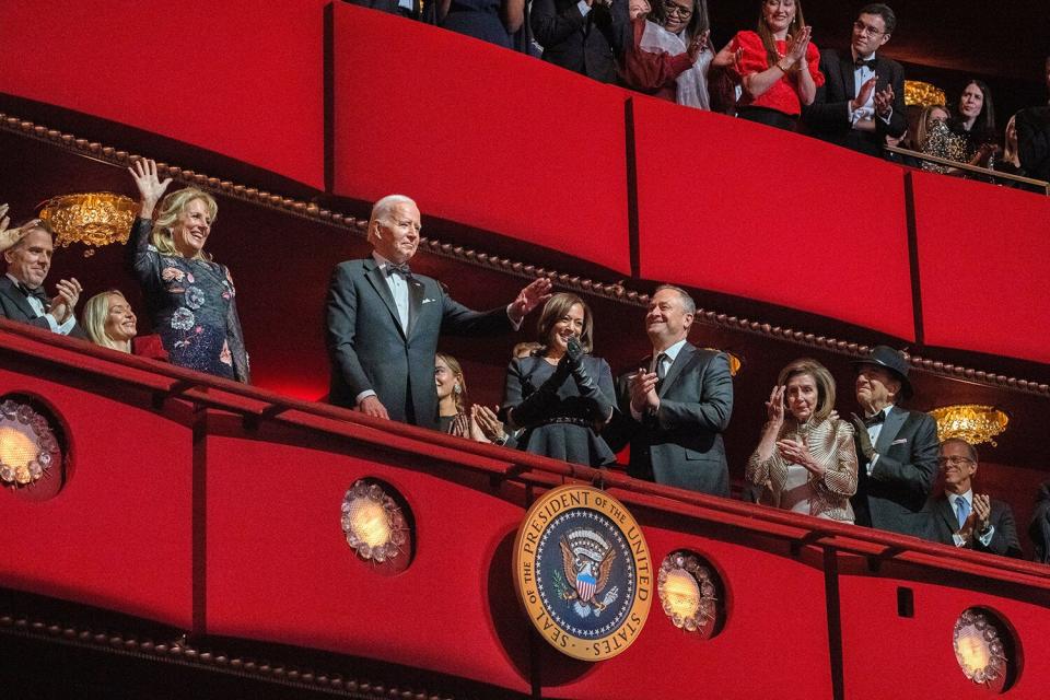 President Joe Biden and first lady Jill Biden wave as they arrive at the 45th Kennedy Center Honors