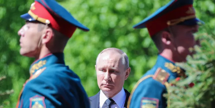 Russian President Vladimir Putin looking somber.