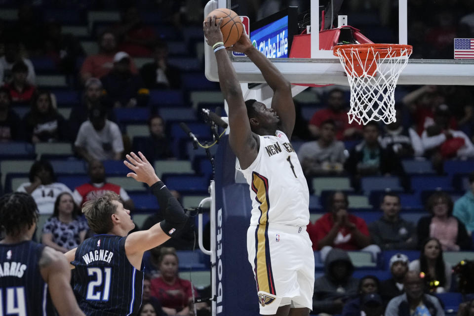 New Orleans Pelicans forward Zion Williamson (1) goes to the basket to slam dunk over Orlando Magic center Moritz Wagner (21) in the first half of an NBA preseason basketball game in New Orleans, Tuesday, Oct. 10, 2023. (AP Photo/Gerald Herbert)