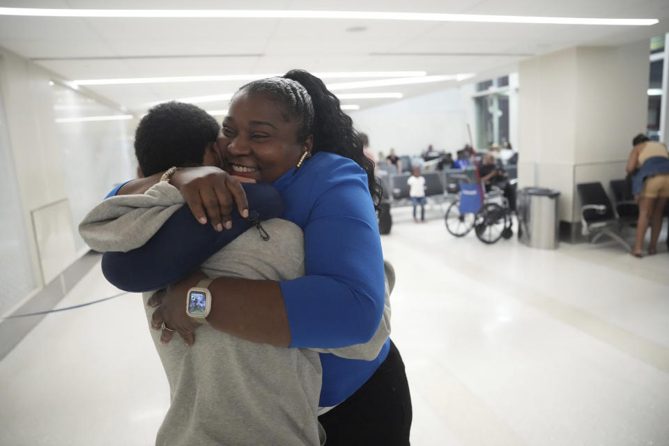 Valerie Laveus greets her nephew Tristan-Ryan Malherbe Daniel as he and his dad arrive for the first time to the United States from Haiti at Fort Lauderdale-Hollywood International Airport, in Fort Lauderdale, Fla., Wednesday, Aug. 9, 2023. (AP Photo/Jim Rassol)