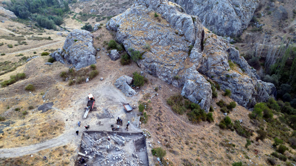 Large rocks on a Turkish hillside along with an archaeological site of Hittite ruins.