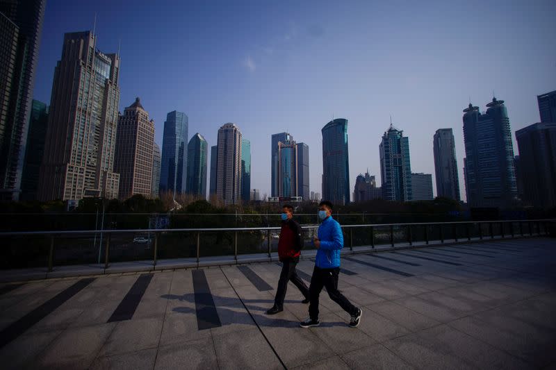 People wearing masks are seen at Lujiazui financial district in Pudong, Shanghai