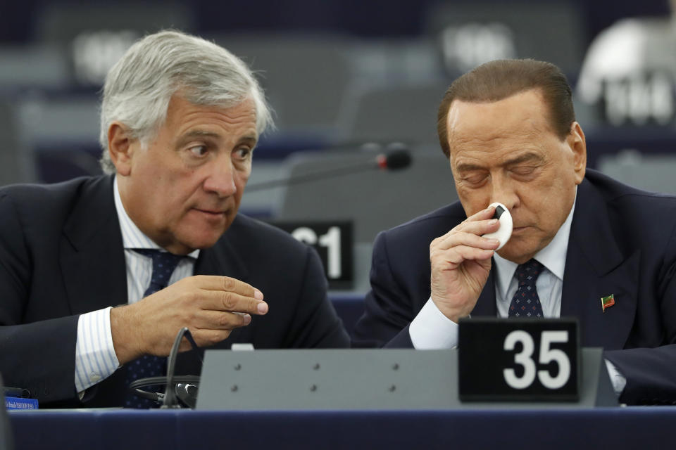 Italy's Antonio Tajani, left, talks with Silvio Berlusconi during a session Wednesday, Sept. 18, 2019 at the European Parliament in Strasbourg, eastern France. The risk of Britain leaving the European Union without a divorce deal remains "very real," European Commission chief Jean-Claude Juncker declared Wednesday as EU lawmakers debated the ramifications of a no-deal Brexit. (AP Photo/Jean-Francois Badias)