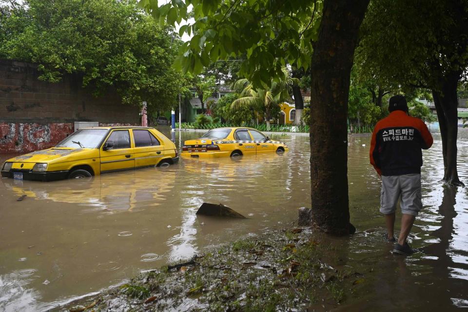 Vehicles are seen in a flooded street of Santa Lucia in Ilopango, El Salvador, during Tropical Storm Amanda (AFP via Getty Images)