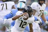 Tulane linebacker Keith Cooper Jr. (48) sacks Central Florida quarterback Thomas Castellanos (12) during the first half of the American Athletic Conference championship NCAA college football game in New Orleans, Saturday, Dec. 3, 2022. (AP Photo/Matthew Hinton)