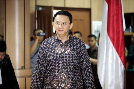 Jakarta's Governor Basuki Tjahaja Purnama walks inside the courtroom during his blasphemy trial at the North Jakarta District Court in Jakarta, Indonesia, December 27, 2016. REUTERS/Bagus Indahono/Pool