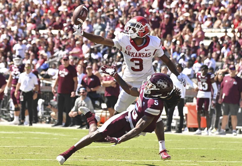 Oct 8, 2022; Starkville, Mississippi, USA; Arkansas Razorbacks defensive back Dwight McGlothern (3) breaks up a pass intended for Mississippi State Bulldogs wide receiver Lideatrick Griffin (5) during a play that would result in a pass interference penalty against Arkansas in the second quarter at Davis Wade Stadium at Scott Field. Mandatory Credit: Matt Bush-USA TODAY Sports