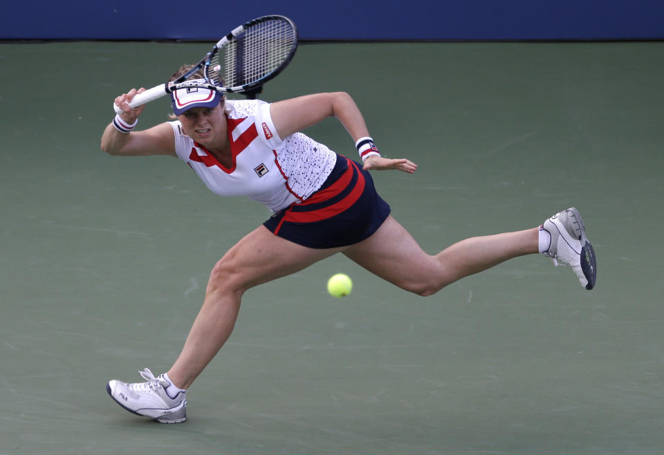 FILE - In this Aug. 29, 2012, file photo, Kim Clijsters returns a shot to Laura Robson in the second round of play at the 2012 U.S. Open tennis tournament in New York. Four-time Grand Slam champion Kim Clijsters is planning another comeback. A mother of three, the Belgian who retired after the 2012 U.S. Open wants a new challenge, she told the WTA in an interview on its website on Thursday, Sept. 12, 2019. (AP Photo/Darron Cummings, File)