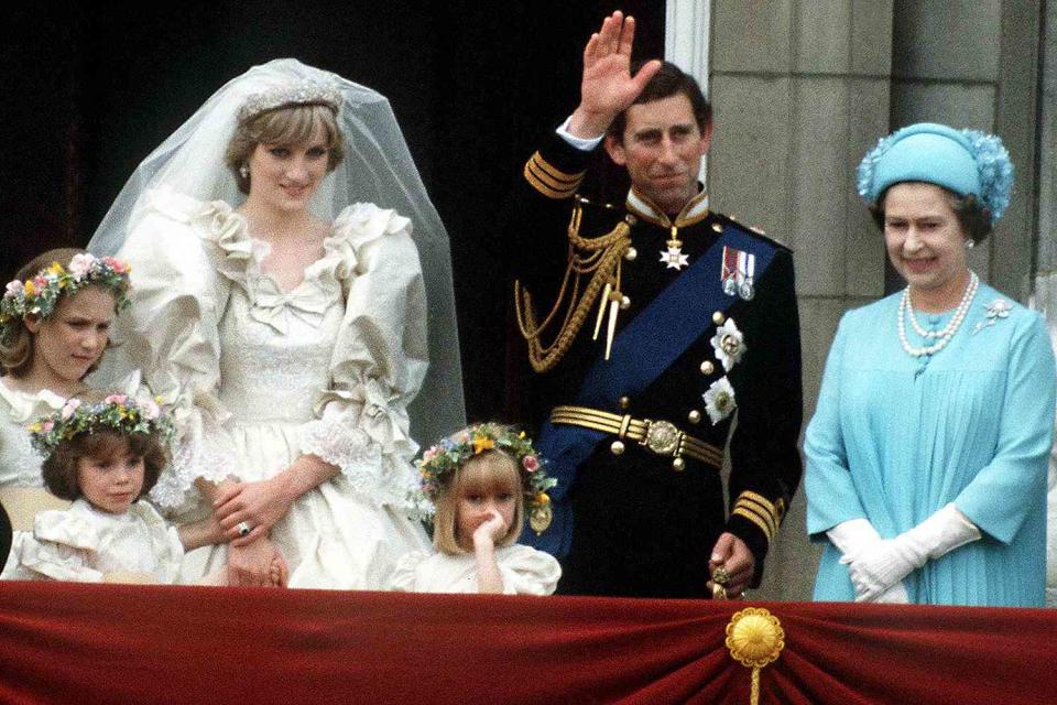 <p>Terry Fincher/Princess Diana Archive/Getty </p> Queen Elizabeth wears blue to Princess Diana and Prince Charles