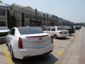 Automobiles are parked near a neighbourhood of villas in Zibo, Shandong Province, China, May 10, 2016. REUTERS/Meng Meng