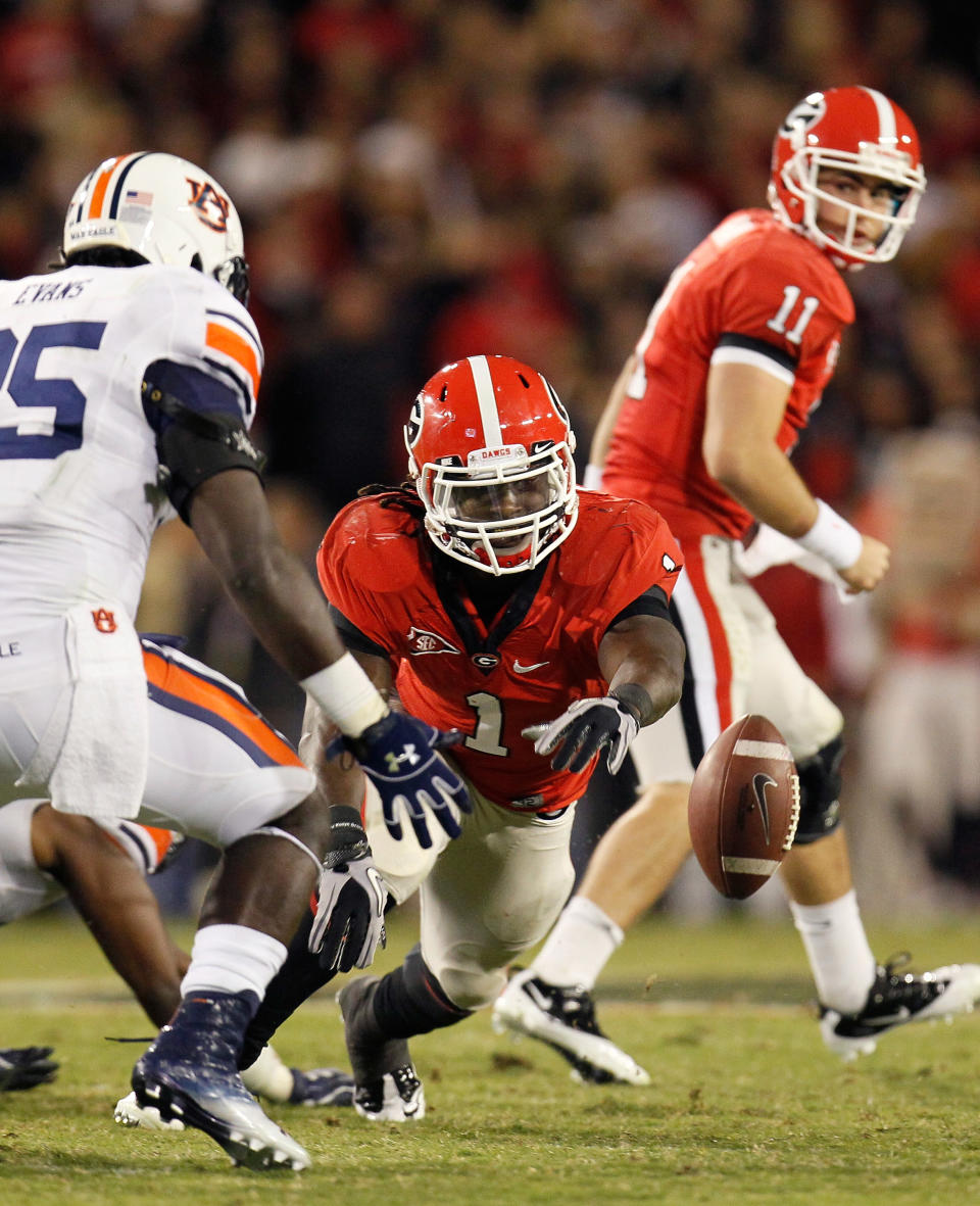 ATHENS, GA - NOVEMBER 12: Isaiah Crowell #1 of the Georgia Bulldogs fumbles the ball as he rushes toward Jonathan Evans #35 of the Auburn Tigers at Sanford Stadium on November 12, 2011 in Athens, Georgia. (Photo by Kevin C. Cox/Getty Images)