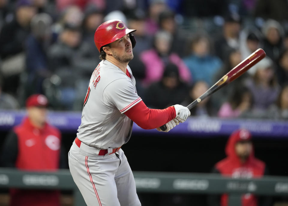 Cincinnati Reds' Kyle Farmer watches his RBI sacrifice fly off Colorado Rockies starting pitcher Antonio Senzatela during the fourth inning of a baseball game Friday, April 29, 2022, in Denver. (AP Photo/David Zalubowski)