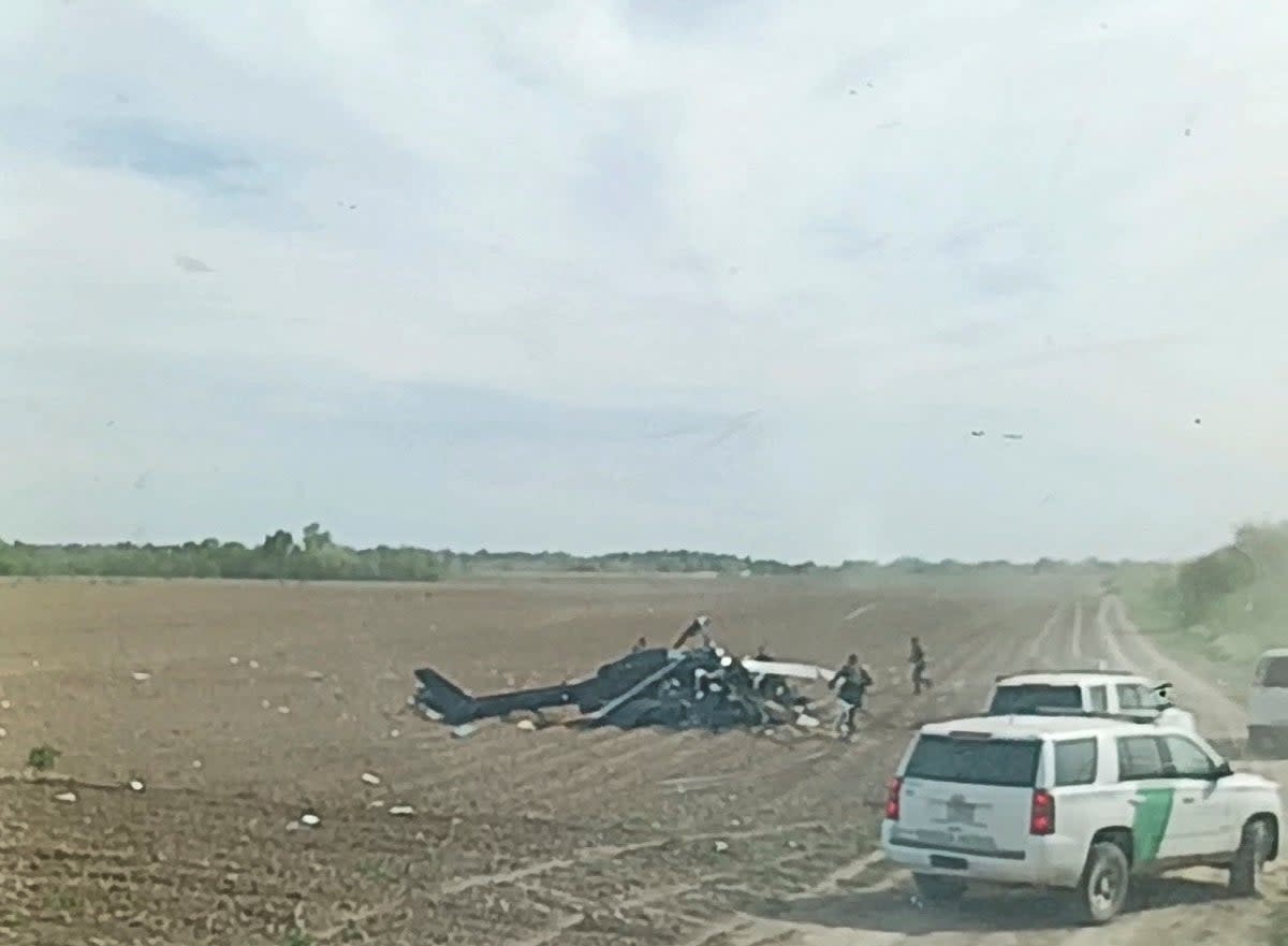 A view from inside a vehicle shows emergency services personnel responding to a helicopter crash near La Grulla, Texas, United States (A.C. via REUTERS)