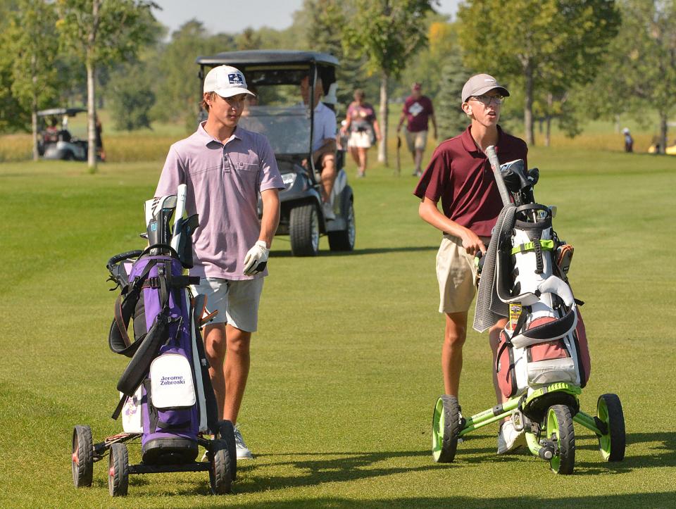 Watertown's Jerome Zebroski (left) and Milbank's Jonathan DeBoer walk to the No. 3 Red green during the Watertown Boys Golf Invite on Tuesday, Sept. 19, 2023 at Cattail Crossing Golf Course.