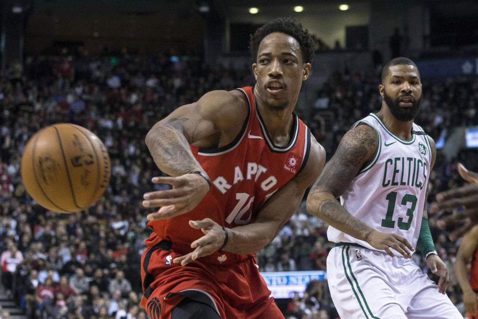DeMar DeRozan passes the ball in front of the Celtics’ Marcus Morris during the second half Tuesday night. (AP)