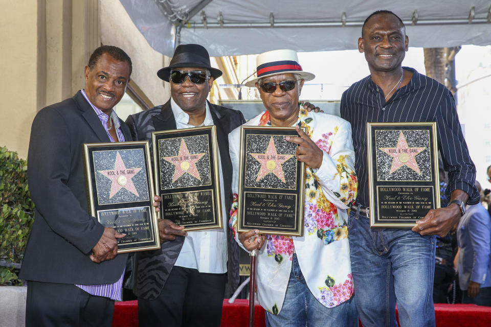 FILE - Robert "Kool" Bell, from left, Ronald "Khalis" Bell, Dennis "DT" Thomas and George Brown attend a ceremony honoring Kool & The Gang with a star on The Hollywood Walk of Fame on Oct. 8, 2015, in Los Angeles. Ronald "Khalis" Bell, a co-founder and singer in the group, has died. He was 68. Publicist Sujata Murthy says Bell died at his home in the U.S. Virgin Islands with his wife by his side. The cause of death has not been released. (Photo by Rich Fury/Invision/AP, file)