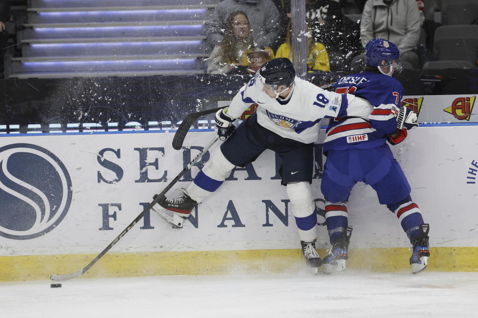 Finland's Rasmus Kumpulainen, left, and USA's Ryan Chesley in action during the IIHF World Junior Championship ice hockey semifinal match between USA and Finland at Scandinavium in Gothenburg, Sweden, Thursday, Jan. 4, 2024. (Adam Ihse/TT via AP)