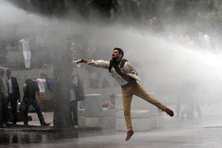 A protester faces a water cannon during clashes with riot police at a demonstration in Ankara on June 16, 2013. Two of Turkey's main trade unions began a nationwide strike to protest at police violence against anti-government demonstrators, a day after Prime Minister Recep Tayyip Erdogan defended his crackdown on an Istanbul protest park