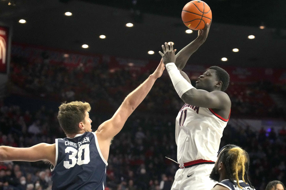 Arizona center Oumar Ballo, top right, shoots over Utah Tech forward Tanner Christensen (30) during the second half of an NCAA college basketball game, Thursday, Nov. 17, 2022, in Tucson, Ariz. (AP Photo/Rick Scuteri)