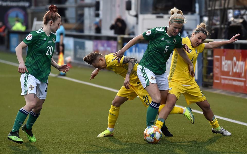 Rebecca McKenna (L) looks on as team-mate Julie Nelson of Northern Ireland battles for possession with Tamila Khimich and Olha Basanska of Ukraine - GETTY IMAGES