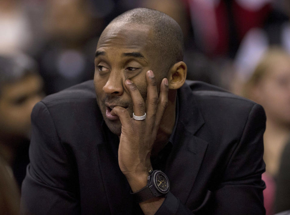 FILE - In this Jan. 19, 2014 file photo, Los Angeles Lakers' Kobe Bryant watches from the sideline during first-half NBA basketball game action against the Toronto Raptors in Toronto. Bryant won't be back on the court for the Lakers this season. The Lakers said Bryant was examined by team physician Dr. Steve Lombardo, who determined that the left knee injury that has kept Bryant out of the lineup still hasn't healed. (AP Photo/The Canadian Press, Frank Gunn, File)