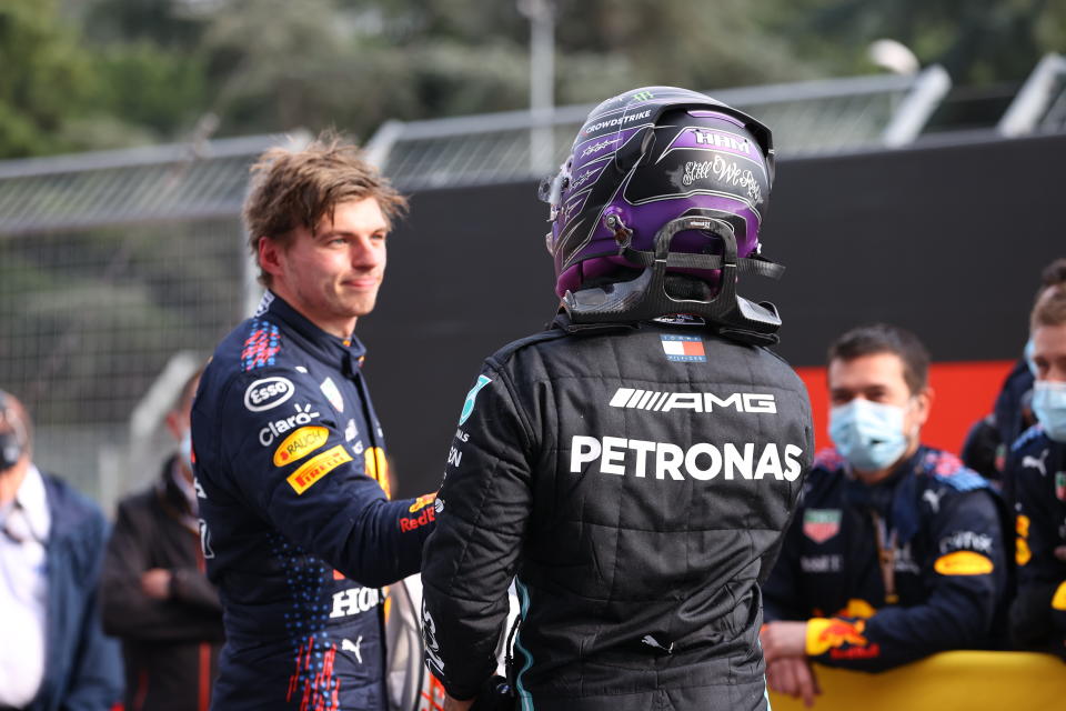 CORRECTS PILOT'S NAME ON THE LEFT - First placed Red Bull's Max Verstappen, left, greets second placed Mercedes Lewis Hamilton at the end of the Emilia Romagna Formula One Grand Prix, at the Imola racetrack, Italy, Sunday, April 18, 2021. (Bryn Lennon/ Pool Via AP)