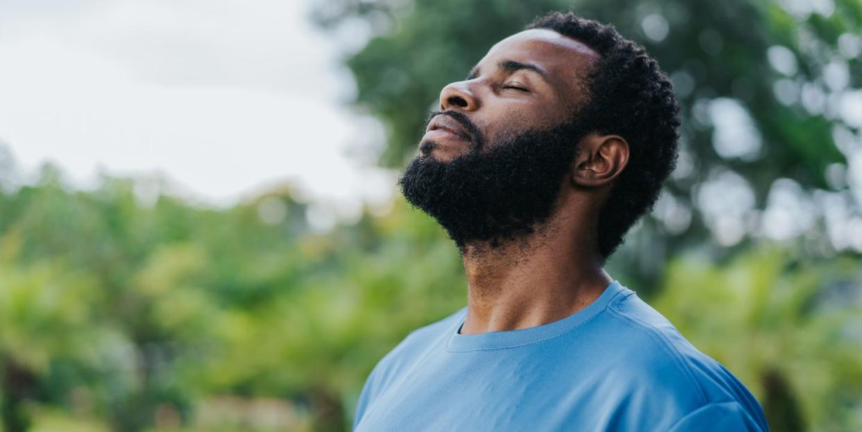 portrait of a man breathing fresh air in nature