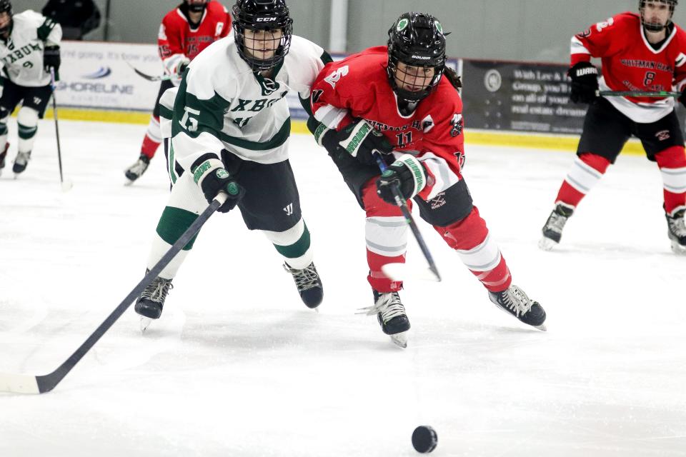 Whitman-Hanson/Silver Lake's Jules Connors and Duxbury's Caylee Higgins battle for the puck during a game at The Bog in Kingston on Thursday, Feb. 9, 2023.