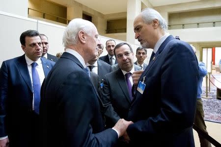 U.N. envoy Staffan de Mistura speaks to Syria's Ambassador to the United Nations Bashar al Jaafari (R) during the Syria peace talks in in Geneva, Switzerland, January 29, 2016. REUTERS/Jean-Marc Ferre/United Nations/Handout via Reuters