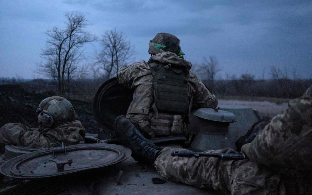 TOPSHOT - Soldiers of the Ukrainian Volunteer Army stand on a MT-LB vehicle as they drive from the front line near Bakhmut, Donetsk region, on March 11, 2023, amid the Russian invasion of Ukraine. (Photo by Sergey SHESTAK / AFP) (Photo by SERGEY SHESTAK/AFP via Getty Images) - Sergey SHESTAK / AFP