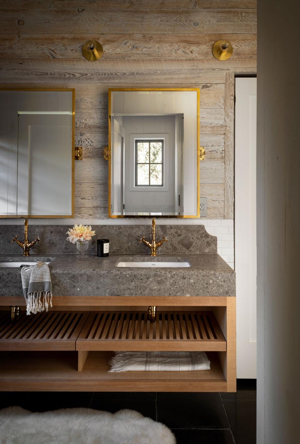 In this bathroom, we see a white oak vanity with Ceppo de Gre marble from ABC Stone. The unlacquered brass mirrors are from Urban Archaeology, and the minimalist wall sconces are from Allied Maker.
